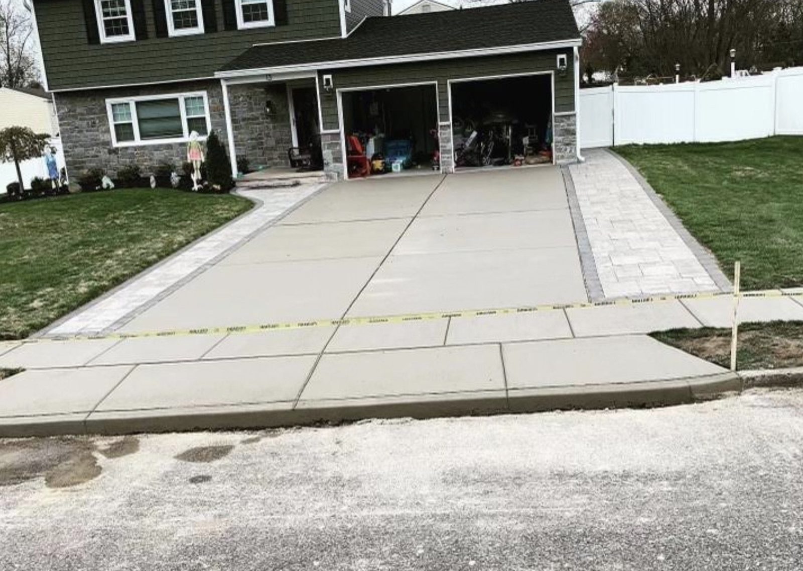 Newly poured concrete driveway leading up to a home